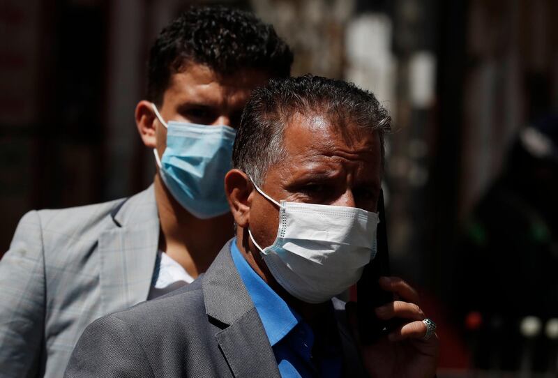 epa08311872 People wear protective face masks as a precaution against the spread of the coronavirus Covid-19, in Sanaa, Yemen, 21 March 2020. Yemen is taking precautionary measures to stem the spread of the coronavirus which causes the Covid-19 disease. Yemen has no confirmed cases of the coronavirus.  EPA/YAHYA ARHAB