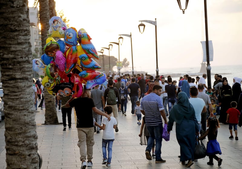 People walk along Beirut's corniche in the Lebanese capital on September 1, 2017, as Muslims mark the first day of the Eid al-Adha holiday.
Muslims across the world celebrate the annual festival of Eid al-Adha, or the festival of sacrifice, which marks the end of the Hajj pilgrimage to Mecca and commemorates prophet Abraham's readiness to sacrifice his son to show obedience to God.  / AFP PHOTO / ANWAR AMRO