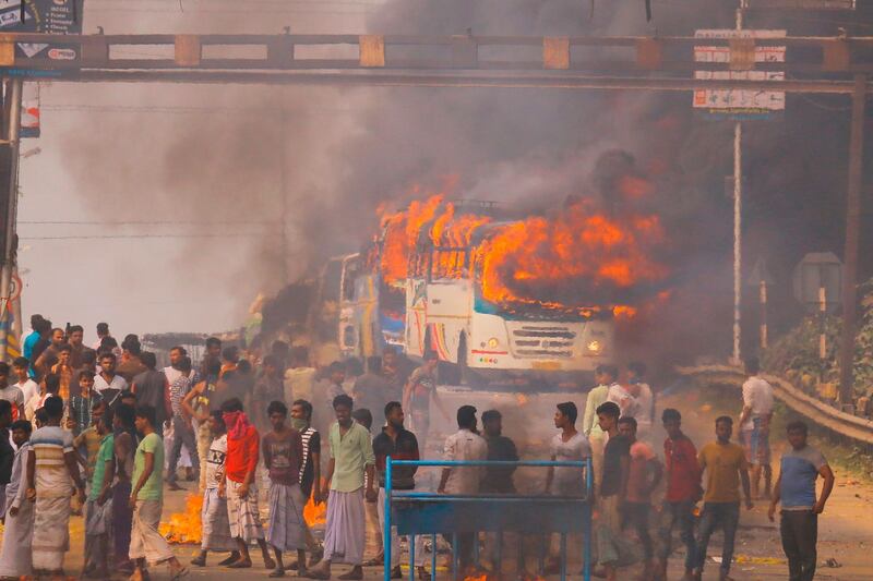 Protesters block a road after setting buses on fire during a demonstration against the Indian government's Citizenship Amendment Bill in Howrah, on the outskirts of Kolkata, West Bengal. AFP