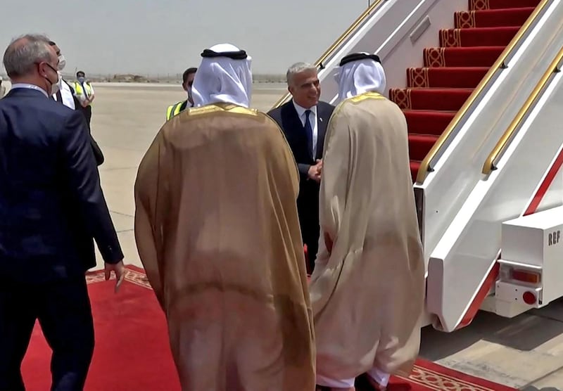 Emirati officials welcome Israeli Foreign Minister Yair Lapid upon his arrival at Abu Dhabi airport on Tuesday. Mr Lapid was making the first official trip by an Israeli minister to the UAE after the two countries normalised ties last year. AFP