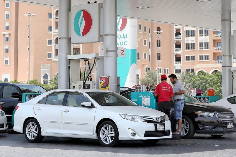 Cars fill up at an Enoc petrol station in Dubai. The price of petrol in the UAE is set to rise. Pawan Singh / The National