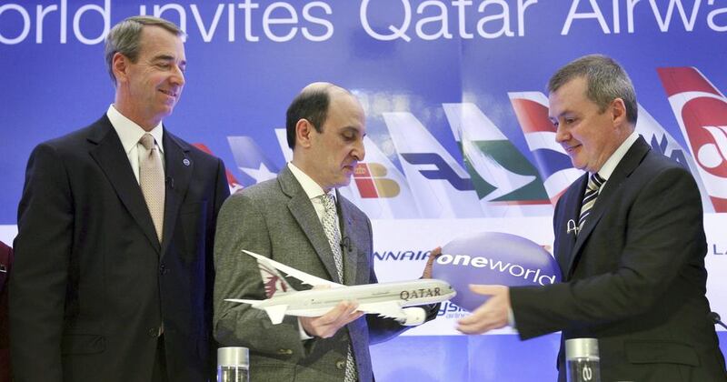 CEO of Qatar Airways Akbar Al Baker, centre, exchanges a gift with International Airlines Group chief executive Willie Walsh. Seth Wenig / AP Photo