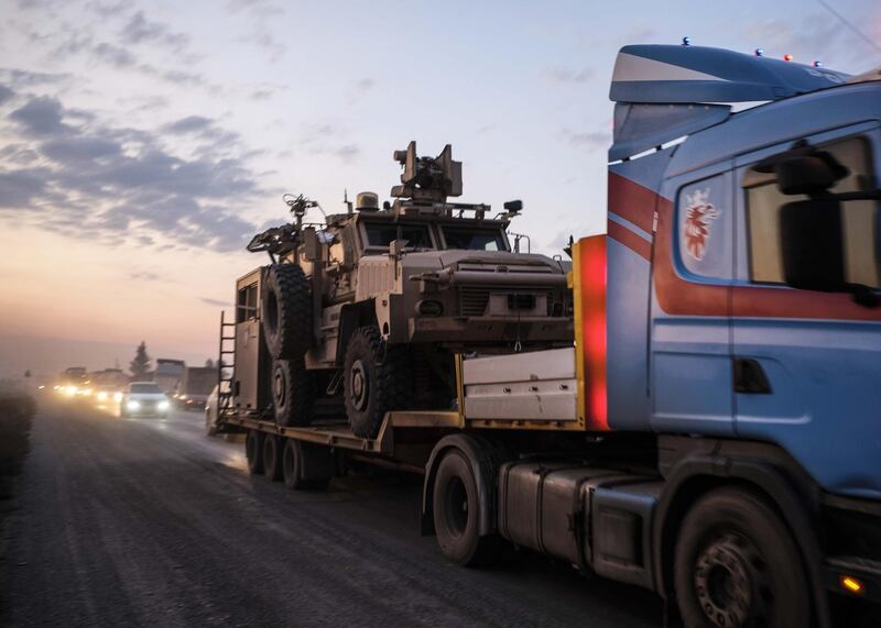 A convoy of U.S. armored military vehicles leave Syria on a road to Iraq in Sheikhan, Iraq. Refugees fleeing the Turkish incursion into Syria arrived in Northern Iraq since the conflict began, with many saying they paid to be smuggled through the Syrian border. Getty Images