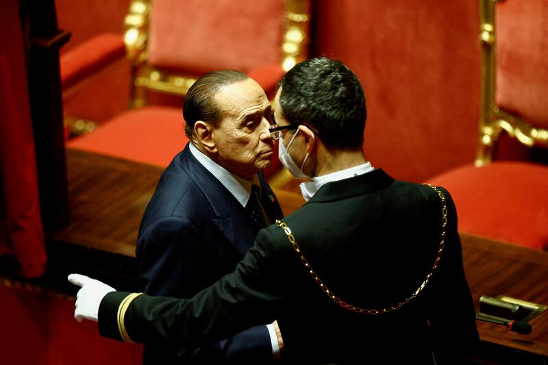 An usher shows Forza Italia leader and former prime minister Silvio Berlusconi the way out of the polling booth after cast his vote during the first voting session to elect the speaker of the Senate in Rome, Italy. Reuters