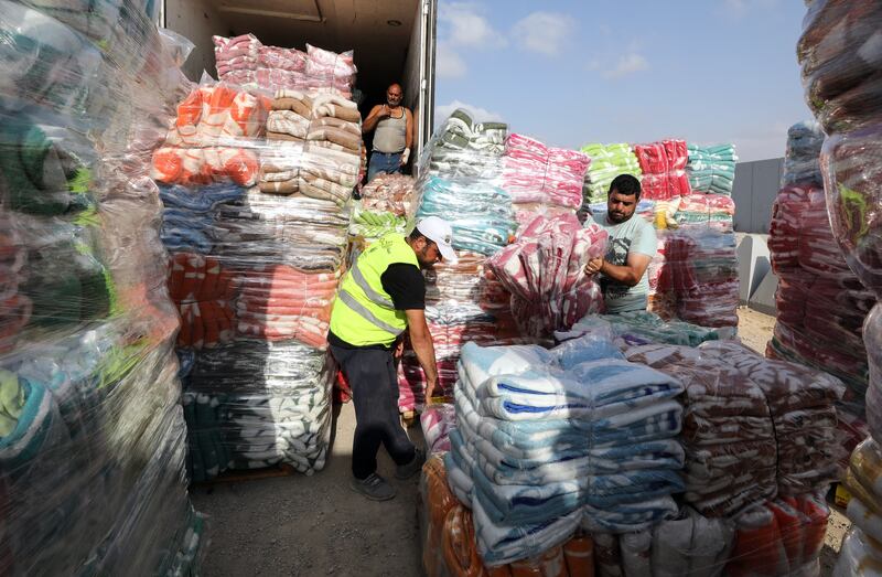 Volunteers handle humanitarian aid bound for Gaza, at the Rafah border crossing in Egypt. EPA