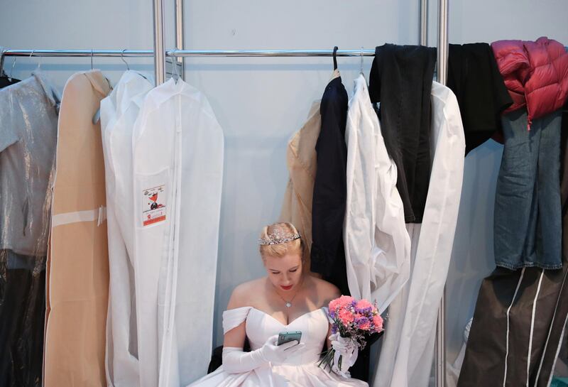 A woman uses her smartphone backstage before the 18th annual Viennese Ball charity event at Gostiny Dvor in Moscow, Russia. Reuters