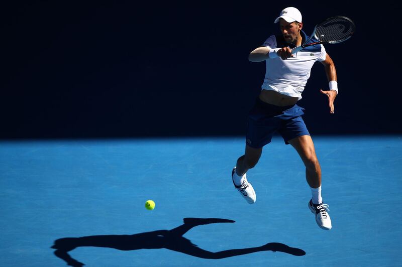 Novak Djokovic of Serbia plays a shot during his first round match against Donald Young. Clive Brunskill / Getty Images