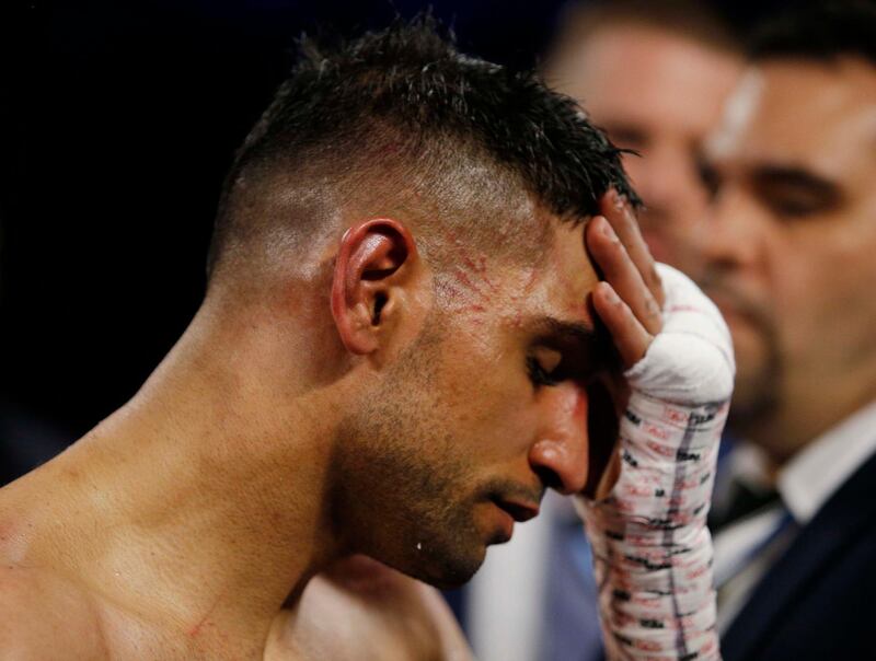 Amir Khan looks dejected after losing the fight. Action Images via Reuters