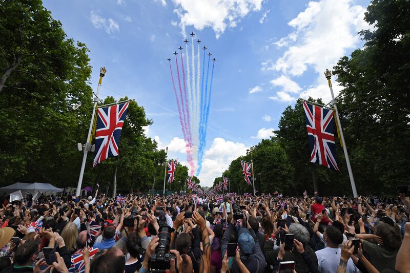 Spectators watch the RAF flypast on The Mall after the Trooping the Colour parade in London. Getty Images