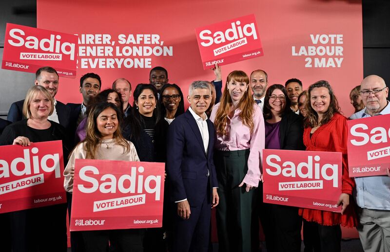 Mayor of London Sadiq Khan (C-L) and Britain's main opposition Labour Party deputy leader and Shadow Levelling Up, Housing and Communities Secretary Angela Rayner (C-R) pose with council candidates during the launching of Khan's manifesto "A fairer, safer, greener London" at the Design District Unit, in London, on April 18, 2024, as part of the political campaign for the London's Mayor elections of May 2.  Sadiq Khan has announced to make the free school meals programme permanent in London, and commits to funding baby banks.  (Photo by JUSTIN TALLIS  /  AFP)