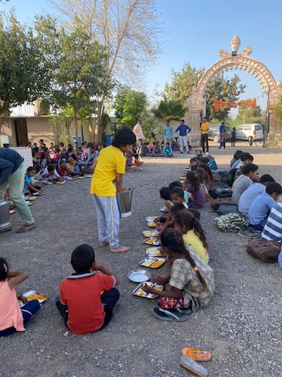 Reyansh feeds the needy in his family's village in India.