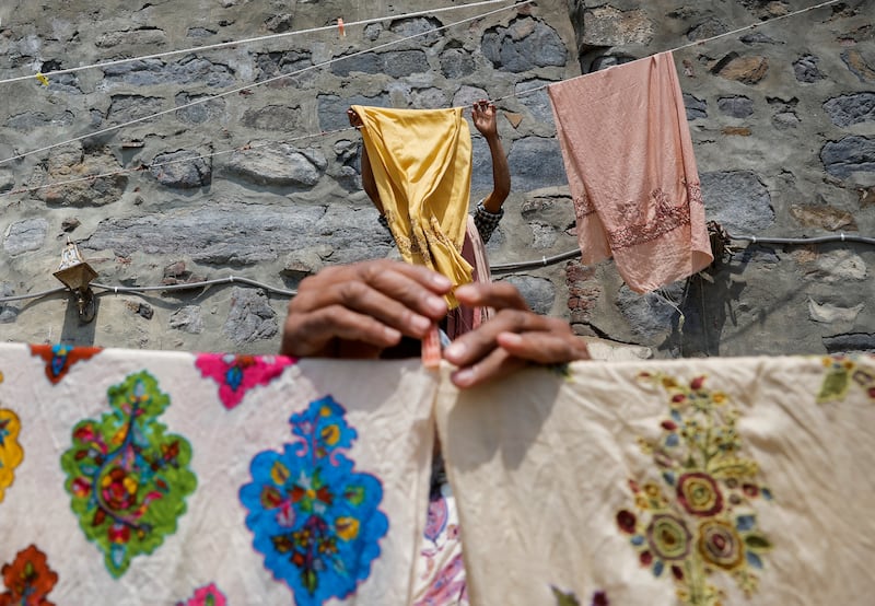 Washermen leave embroidered shawls to dry in the sun, on the banks of river Jhelum, in Srinagar, India. Reuters
