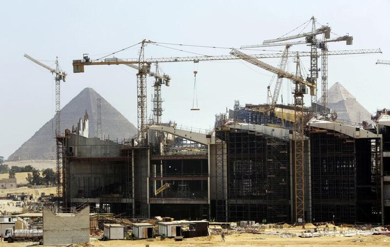 Cranes work at the site of the Grand Egyptian Museum near the Giza Pyramids on the outskirts of Cairo. Amr Nabil / AP Photo