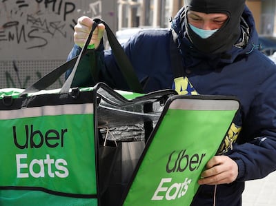 FILE PHOTO: An Uber Eats food delivery courier closes a bag with an order during a lockdown, imposed to prevent the spread of coronavirus disease (COVID-19), in central Kiev, Ukraine April 2, 2020. REUTERS/Valentyn Ogirenko/File Photo