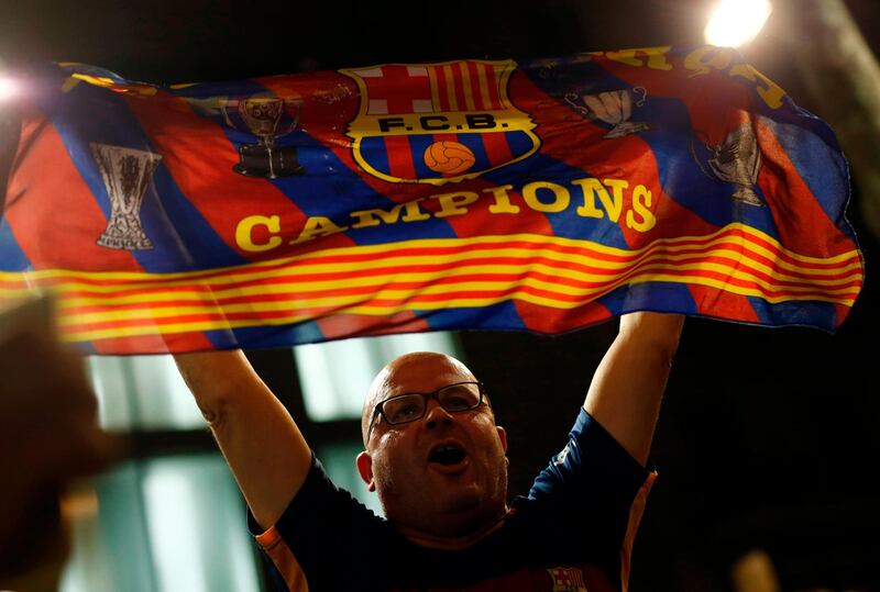 A Barcelona supporter celebrates at the end of their Copa del Rey final against Sevilla in Barcelona. Pau Barrena / AFP
