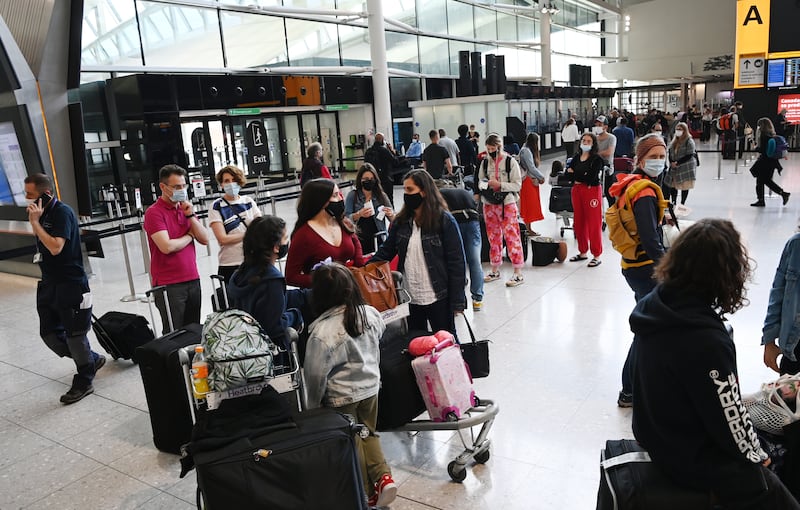 Passengers queue for flights at Heathrow Airport.