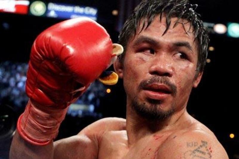 LAS VEGAS - NOVEMBER 14: Manny Pacquiao celebrates his 12 round TKO victory against Miguel Cotto during their WBO welterweight title fight at the MGM Grand Garden Arena on November 14, 2009 in Las Vegas, Nevada.   Al Bello/Getty Images/AFP