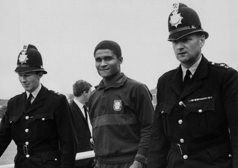 Eusebio with a police escort to protect him from autograph seekers at the 1966 World Cup. He won the Golden Boot at the tournament, scoring nine times. Central Press / Getty Images