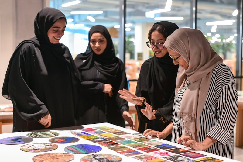 The grant programme aims to help Emiratis pursue projects helping their creative, intellectual and professional growth. Pictured: Najat Makki (right) with young Emirati artists at a workshop at the Cultural Foundation, Abu Dhabi. Khushnum Bhandari / The National