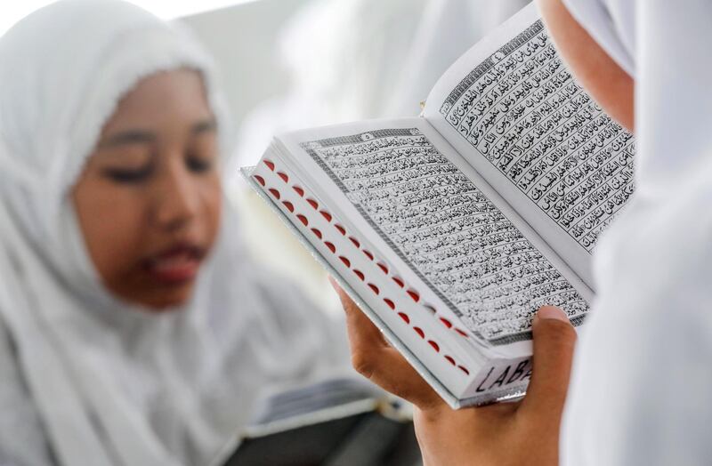 Indonesian students read the Koran on the first day of Ramadan at Ar-Raudhatul Hasanah Islamic boarding school in Medan, North Sumatra, Indonesia.  EPA