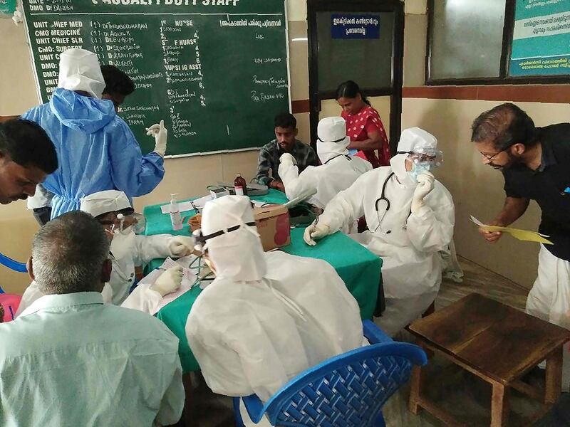Medical personnel wearing protective suits check patients at the Medical College hospital in Kozhikode on May 21, 2018. A deadly virus carried mainly by fruit bats has killed at least three people in southern India, sparking a statewide health alert May 21. Eight other deaths in the state of Kerala are being investigated for possible links to the Nipah virus, which has a 70 percent mortality rate.
 / AFP / -
