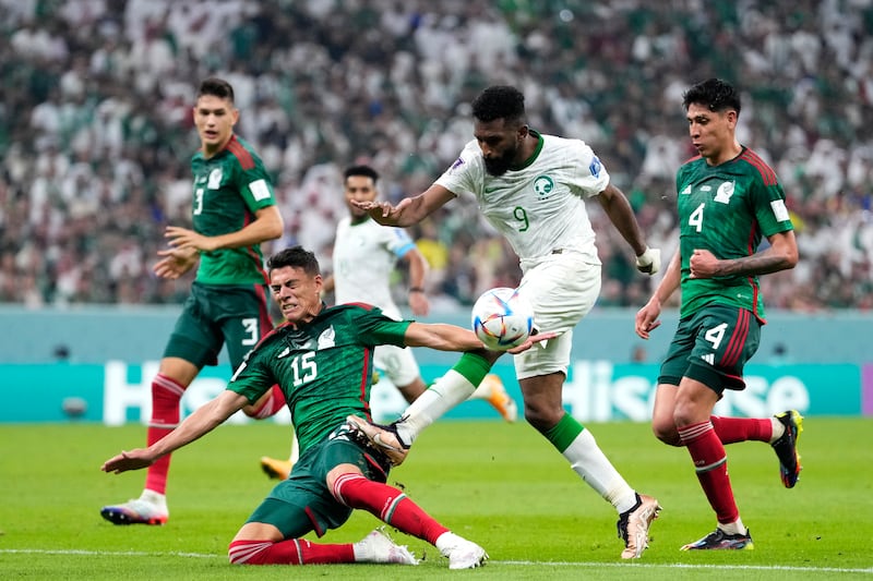 Mexico's Hector Moreno tussles with Saudi Arabia's Firas Al Buraikan. AP