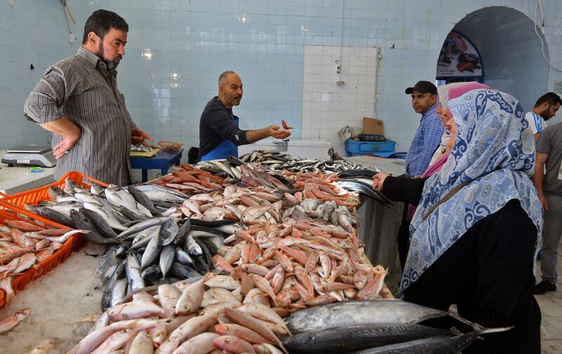 Libyans buy fresh fish at a market as residents of the capital Tripoli get ready for the beginning of Ramadan.  AFP