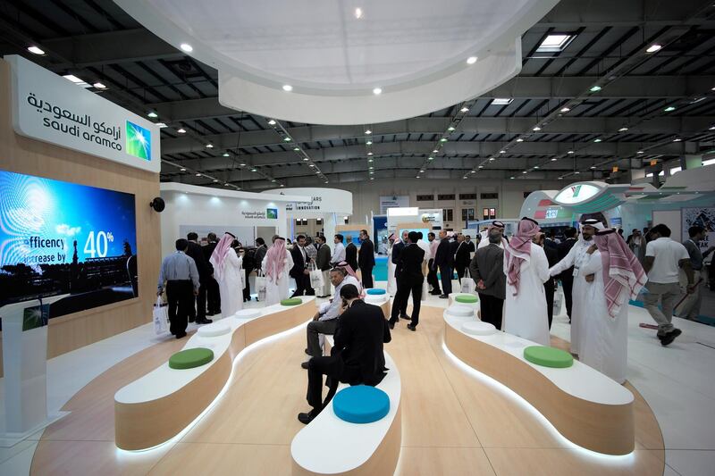 FILE PHOTO: Visitors are seen at the Saudi Aramco stand at the Middle East Process Engineering Conference & Exhibition in Manama, Bahrain, October 9, 2016. REUTERS/Hamad I Mohammed/File Photo