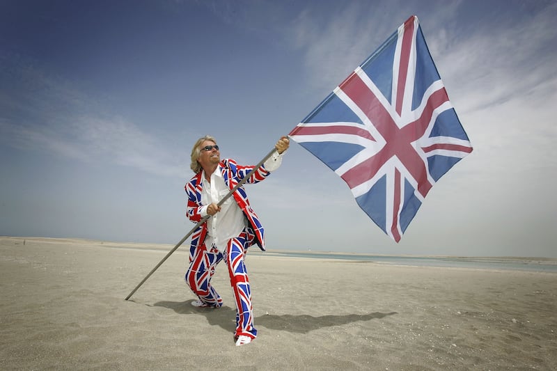 Sir Richard Branson plants a UK flag into the sand on the World Islands in Dubai, on March 29, 2006. Getty Images