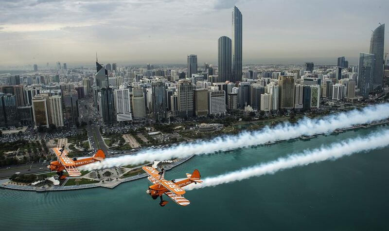 The Breitling Wingwalkers team perform air acrobatics over the Abu Dhabi skyline. Joerg Mitter / Breitling SA via AP Images