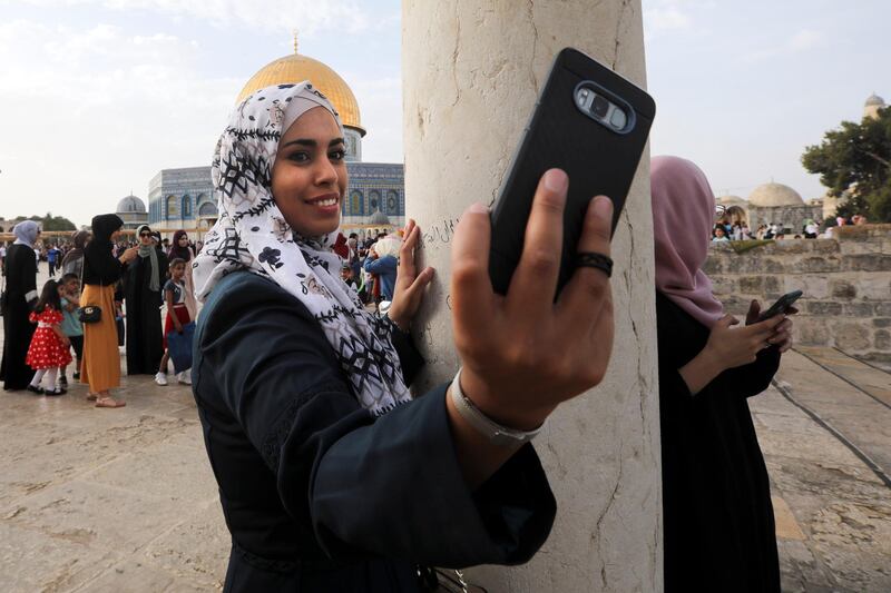 Palestinians attend of Eid al-Fitr holiday celebrations by the Dome of the Rock shrine in Jerusalem. AP