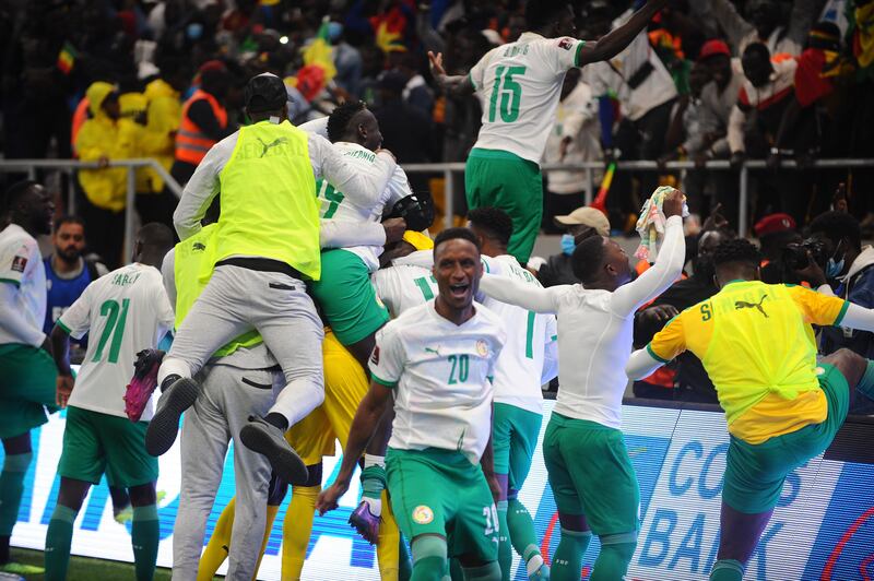 Senegal players celebrate after their penalty shoot-out win over Egypt that saw them qualify for the World Cup finals in Qatar. EPA