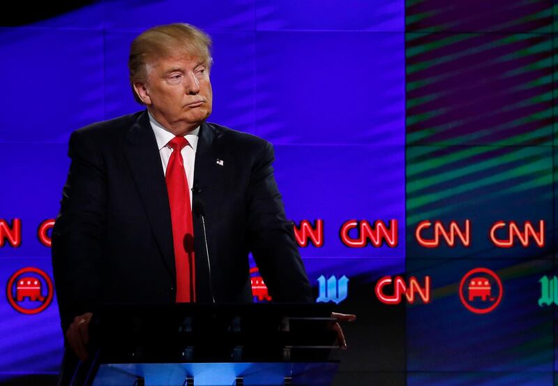 (FILES) In this file photo taken on March 10, 2016 Donald Trump (L) listens to Texas Senator Ted Cruz (not pictured) speak during the CNN Republican Presidential Debate in Miami, Florida. - Branded "enemy of the people" by US President Donald Trump, the US news media is responding with a campaign aimed at countering the president's narrative and highlighting the importance of a free press. More than 200 news organizations are to participate in a coordinated campaign on August 16, 2018, with editorials about the importance of an independent media and a social media hashtag #EnemyOfNone. (Photo by RHONA WISE / AFP)