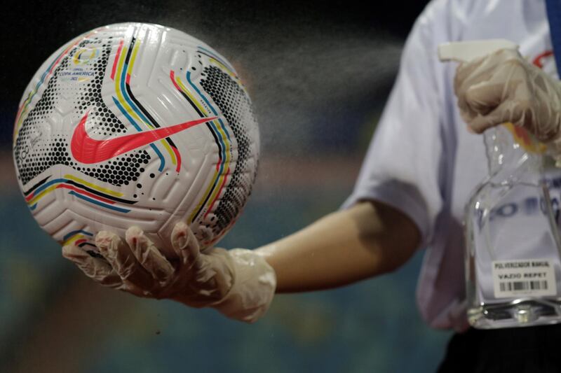 A ball is disinfected during the Copa America match between Peru and Colombia at Estadio Olimpico Pedro Ludovico in Goiania, Brazil. EPA