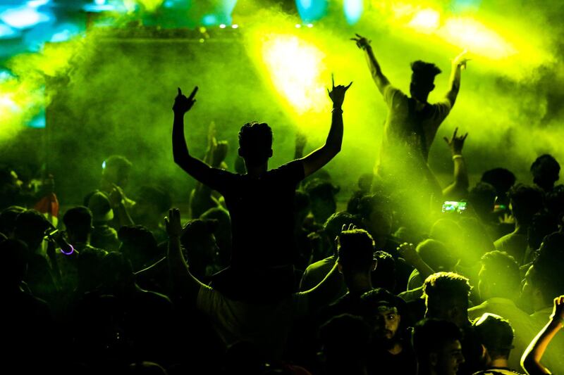Youths attend an electronic dance music event, during the annual Baghdad Summer Festival at the People's Hall in the Iraqi capital.  AFP