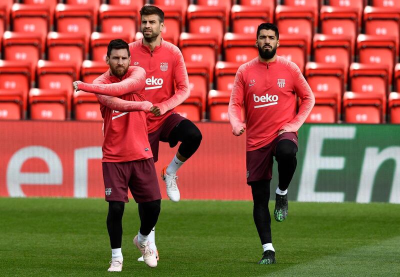 Lionel Messi, Gerard Pique and Luis Suarez warm up during training at Anfield. EPA