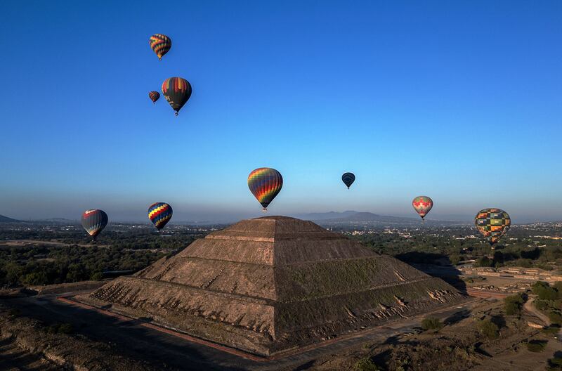 Hot-air balloons rise over the Teotihuacan pyramids in Mexico State during spring equinox celebrations. AFP