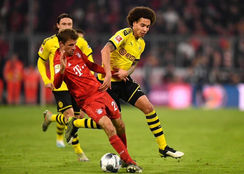 Bayern's Thomas Mueller and Dortmund's Axel Witsel tussle for the ball. EPA