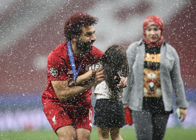 Salah celebrates with his daughter Makka and wife Magi. Reuters