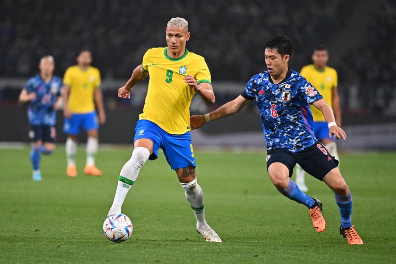 Richarlison of Brazil controls the ball under pressure from Wataru Endo of Japan during the international friendly match at National Stadium. Getty Images