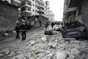 Rescuers walk amidst rubble scattered across a street following an air strike in Idlib province last week. AFP