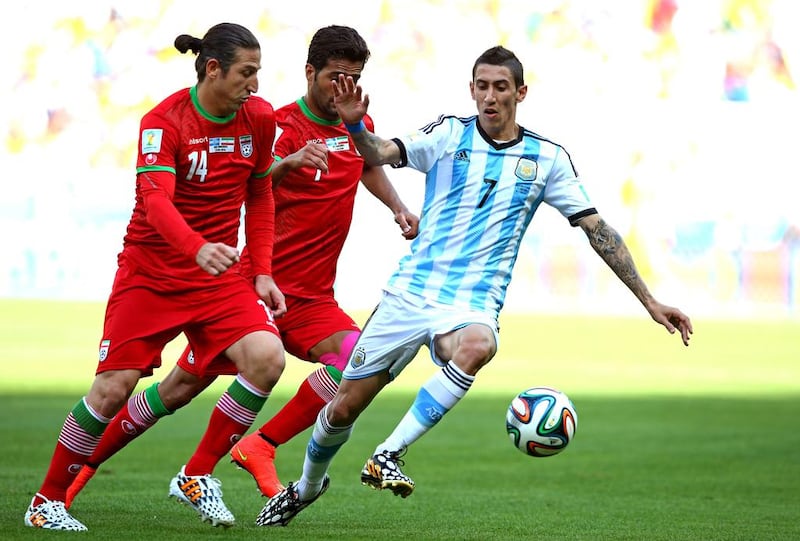 Angel di Maria of Argentina is challenged by Andranik Teymourian of Iran during their match on Saturday at the 2014 World Cup in Belo Horizonte, Brazil. Paul Gilham / Getty Images