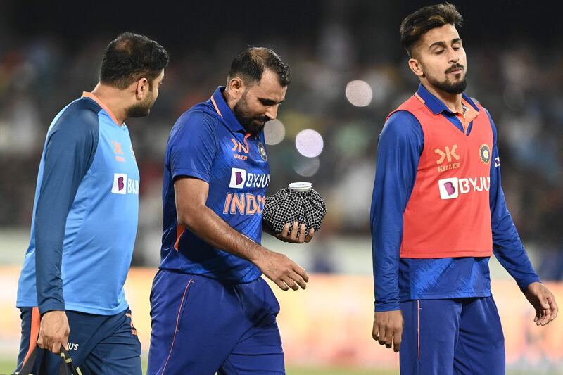 India pacer Mohammed Shami walks back to the pavilion after injuring his left hand. AFP