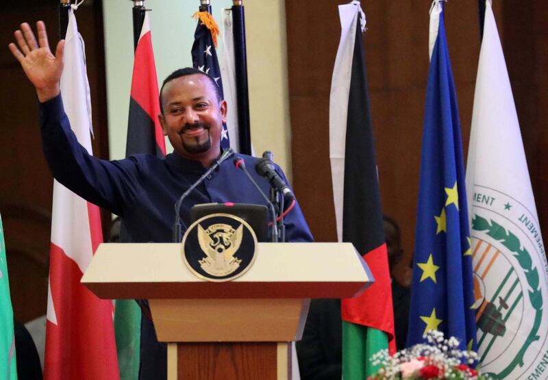 Prime Minister of Ethiopia Abi Ahmed waves at the audience after a speech during the ceremony for the signing of the power sharing agreement between Sudan's military council and the opposition, in Khartoum, Sudan. EPA/MORWAN ALI  EPA-EFE/MORWAN ALI