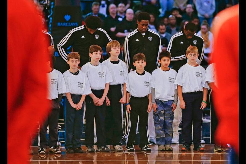 Children who were attending a birthday party at the game join Brooklyn Nets players on the court observe a moment of silence for the victims of a mass shooting at Sandy Hook Elementary School in Newtown, Connecticut. Ray Stubblebine / Reuters