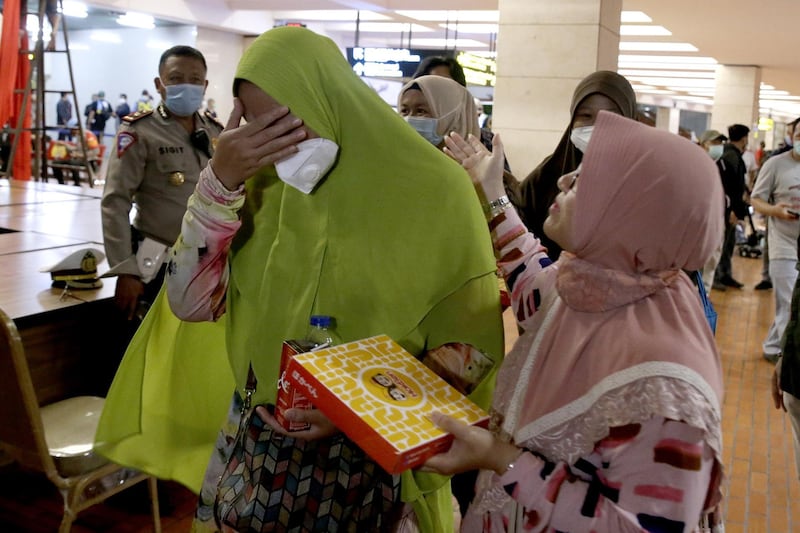 Relatives of Sriwijaya Air plane passengers arrive at the crisis center in Soekarno-Hatta International Airport following the report that Sriwijaya Air plane flight SJ182 lost contact shortly after taking off, at Tanjung Priok Port in Jakarta, Indonesia.  EPA