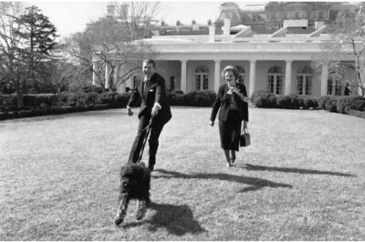 Ronald Reagan and his pet dog Lucky, with Margaret Thatcher in the White House Rose Garden in 1985. AP Photo