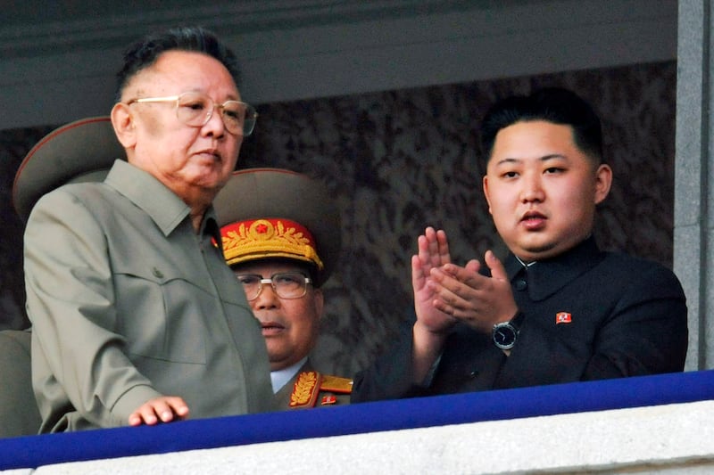Late North Korean leader Kim Jong-il with his son Kim Jong-un on the balcony as they attend a military parade marking the 65th anniversary of the communist nation's ruling Workers' Party in Pyongyang, October 2010. Kyodo News / AP