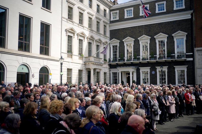 People gather in St James's Square. PA