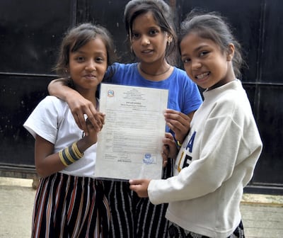 Sujata, right, celebrates getting her birth certificate with her friends. Courtesy SathSath